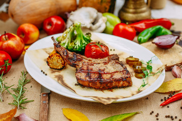 Autumn table setting with pumpkins. Thanksgiving dinner.Tomahawk Pork Steak with Vegetables