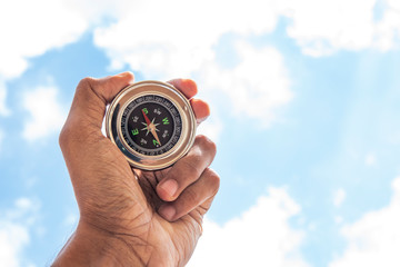Hand holding Compass for finding direction