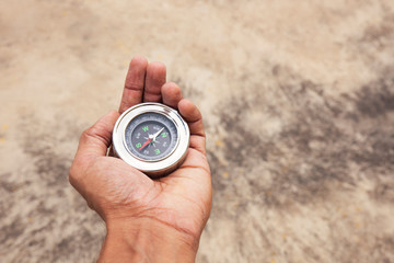 Hand holding Compass for finding direction