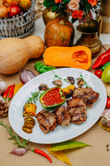 Autumn table setting with pumpkins. Thanksgiving dinner.grilled meat with vegetables