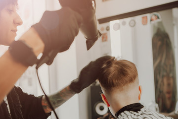 Children's haircut hairdresser in barber shop