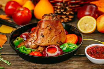 Autumn table setting with pumpkins. Thanksgiving dinner.baked pork shank with vegetables