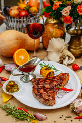 Autumn table setting with pumpkins. Thanksgiving dinner. Steak with Vegetables