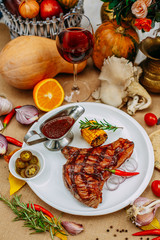 Autumn table setting with pumpkins. Thanksgiving dinner. Steak with Vegetables