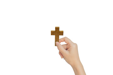 Female hand holding wooden cross isolated on white background.