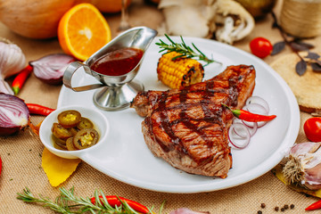 Autumn table setting with pumpkins. Thanksgiving dinner. Steak with Vegetables
