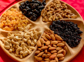 dried fruits and nuts on a wooden plate, catering, buffet