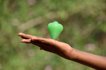 hand holding a lattu  or game players 