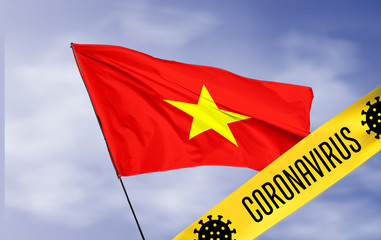 Coronavirus (COVID-19) outbreak warning against a Vietnam Flag background. Covid-19 outbreak in Vietnam