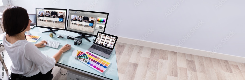 Poster Female Designer Working On Multiple Computer