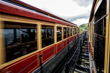 Aerial view of Red tram retro style run to the top hill with passenger  to Fansipan mountain, Fansipan tram, Sapa, Lao Cai, Vietnam.
