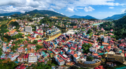 Fototapeta premium Top view aerial photo from flying drone of a Sapa town with development buildings, Lao Cai, Vietnam.