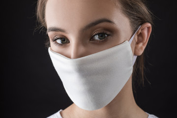 Woman wearing face protective mask on face against Coronavirus. COVID-19 Pandemic.
