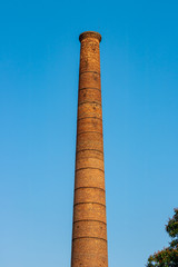 Big chimney composed of yellow brick..