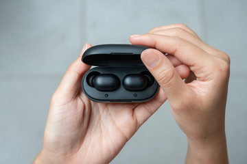 Close up of woman is open the black true wireless earbuds case