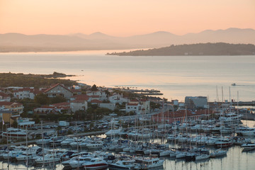 Cove, yachts, ancient city Tribunj pink dawn