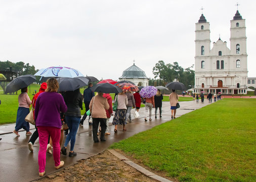 Women with umbrellas go to Church to pray