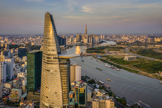 Aerial panoramic cityscape view of HoChiMinh City and Bitexco tower , Vietnam with blue sky at sunset. 