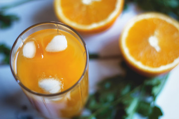 glass of orange juice with ice