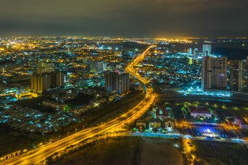 Fototapeta na wymiar Top view aerial of Nguyen Van Linh road, area Phu My Hung new urban, Ho Chi Minh City with development buildings, transportation, energy power infrastructure. Financial in developed Vietnam.