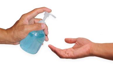 The hand is holding a bottle of hand washing gel isolated on the white background