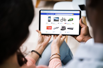 Couple Shopping Online On Tablet
