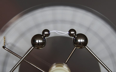Spinning Wimshurst machine induces a small lightning bolt.