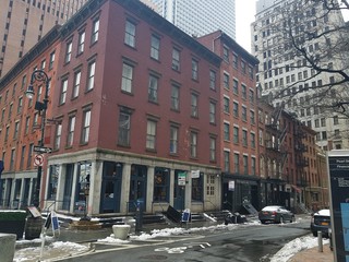 A street in New York city with a view of the road and a yellow taxi