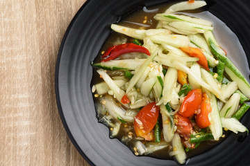 Spicy cucumber salad on black plate, Delicious Thai food, Top view