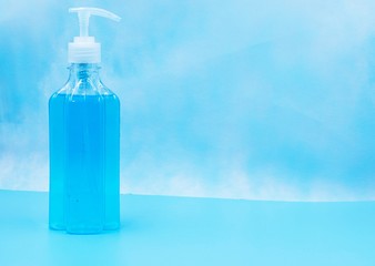 Hand sanitizer is a liquid or gel generally used to decrease infectious agents on the hand to clean hand on blue background