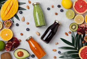 Healthy fresh fruit smoothies with assorted ingredients served in glass bottles. Colorful smoothie, healthy detox vitamin diet or vegan food concept, fresh vitamins. 