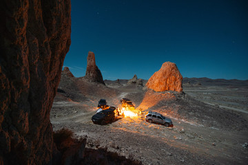 Cars parked around campfire in Monument Valley