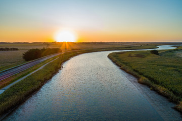 Tarwin River flowing into the sunset among agricultural land - aerial view