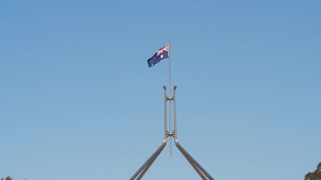 aus parliament flag long shot slow motion canberra australia flag waving in wind