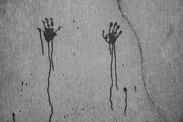 Horror image - footprints of two hands with dripping blod on grungy wall with copy space