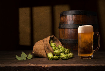 Beer barrel with beer glasses on wooden background