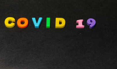Concept of Covid-19 with alphabets words on black background
