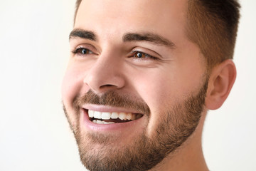 Fototapeta premium Handsome smiling young man on white background