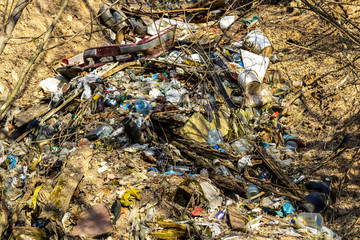 garbage thrown out in nature among grass. Waste polluting world. The concept of ecology and environmental pollution.