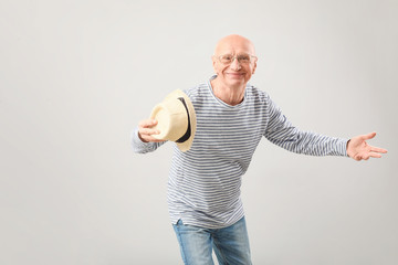 Portrait of happy elderly man on grey background