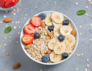 Healthy Breakfast oatmeal with fruit, berries and nuts.