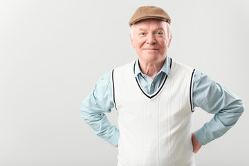 Portrait of elderly man on grey background
