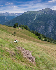 Fototapeta na wymiar Hay harvest on the Kobl Meadows above Pfunds, Upper Inn Valley, Tyrol, Austria