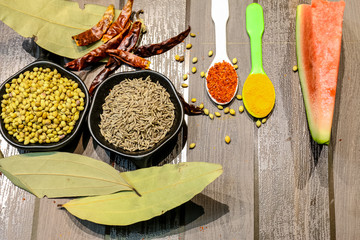 Herbs and Spices with colorful wooden background