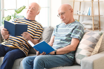 Fototapeta na wymiar Elderly men reading books at home