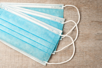 Surgical masks on wooden background