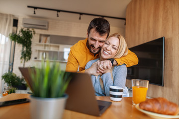 Young couple having breakfast at home.