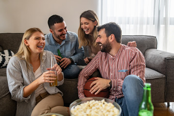 Group of friends preparing to watch football game at home