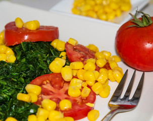 Fototapeta na wymiar spinach, tomato and corn salad, healthy diet concept
