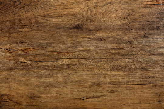 Beautiful texture of natural dark oak with cracks, spots and a horizontal pattern of fibers.